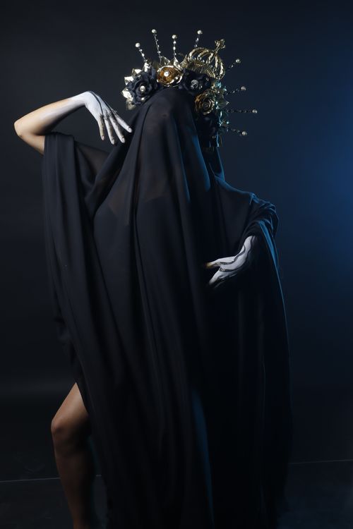 Free Mysterious, artistic portrait with a draped figure and intricate headpiece. Stock Photo