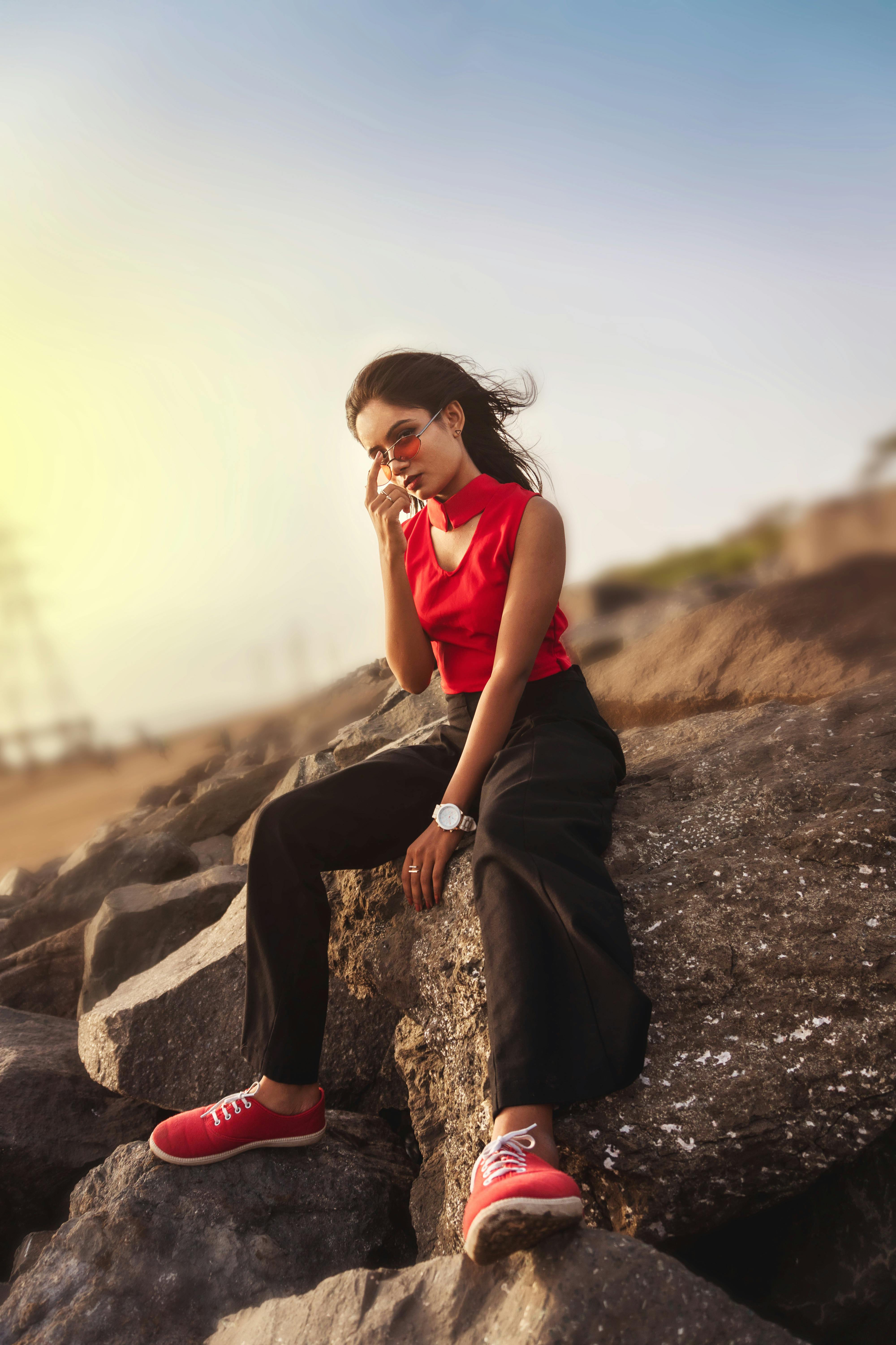 women s red sleeveless top and black pants