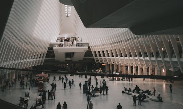 The bustling interior of The Oculus transit hub in New York City with modern architectural design.
