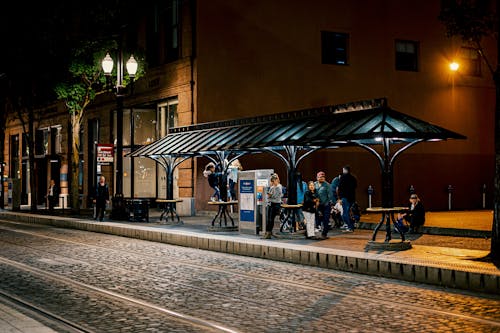 Free Photo of People on Waiting Shed During Nighttime Stock Photo