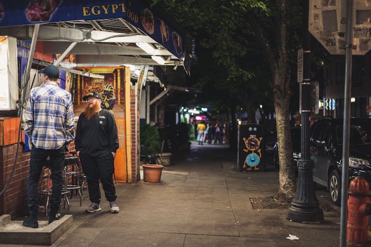 Two Men Standing Outside Restaurant