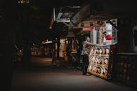 菜单明亮的街头小吃摊，在充满活力的夜间场景中捕捉着互动