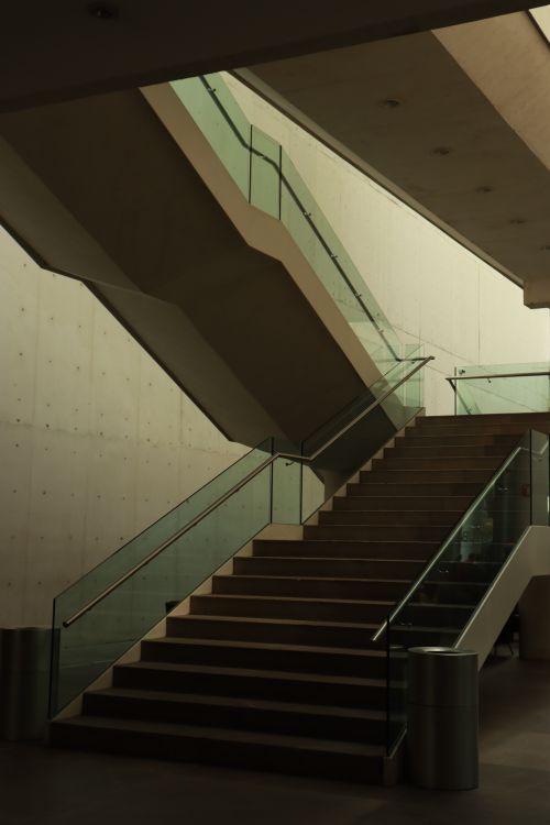 Free Elegant modern staircase with glass railings in a contemporary building interior. Stock Photo