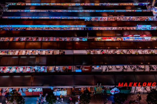 Experience the bustling energy of Bangkok's iconic Maeklong night market with vibrant stalls.