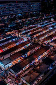 Explore the bustling night market in Bangkok, Thailand, from above.