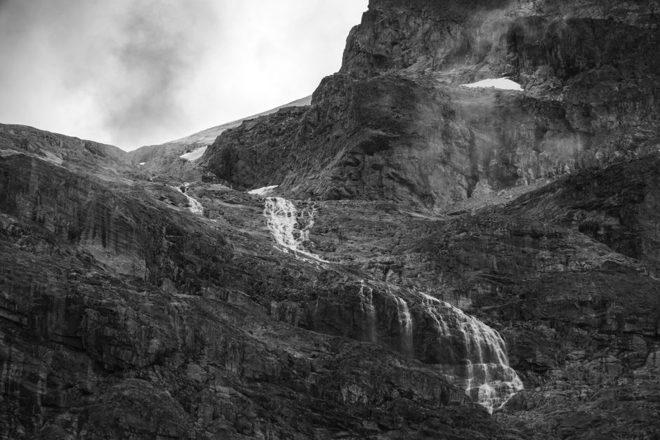 A captivating black and white view of a waterfall cascading down rocky terrain at Mount Currie.