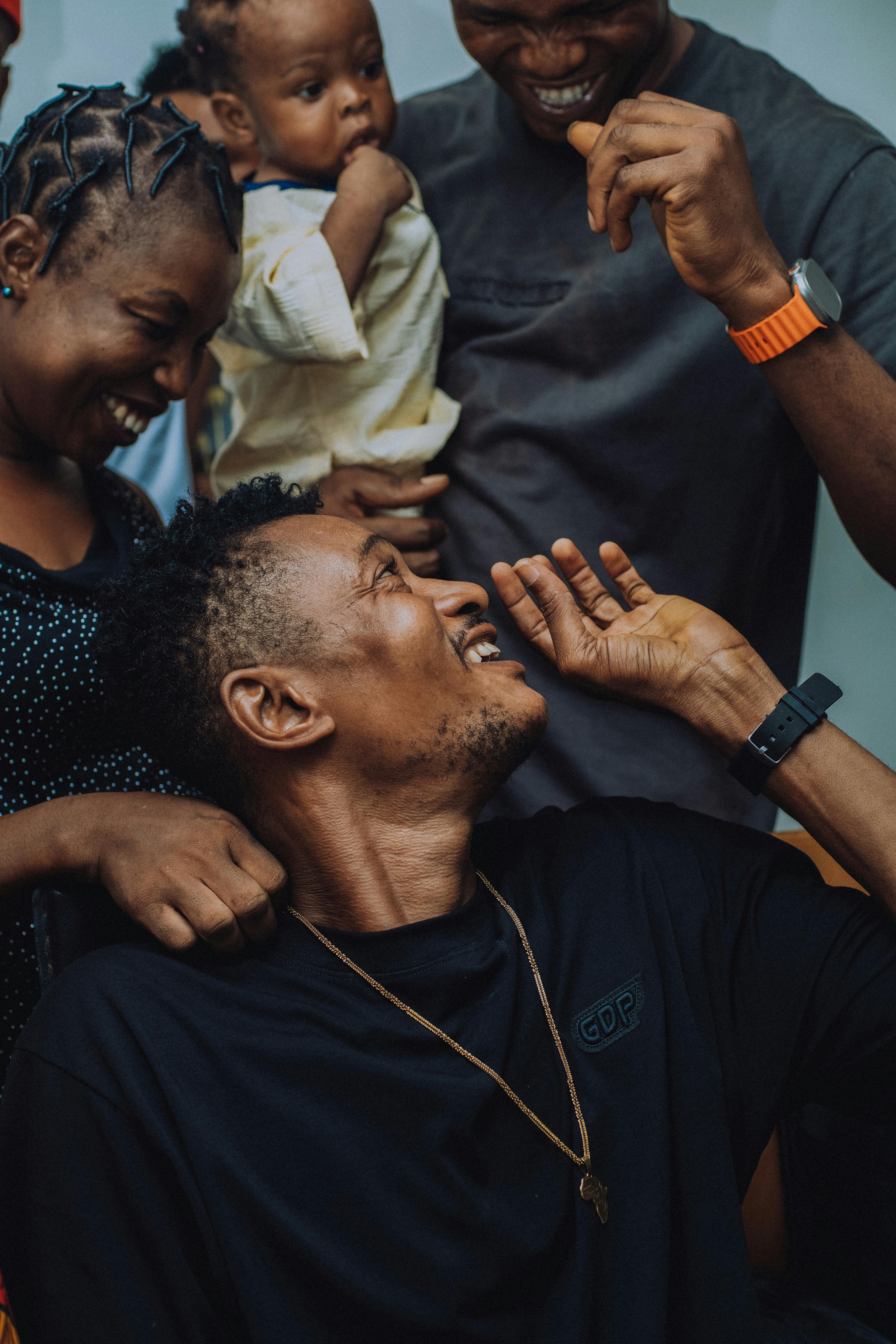 A joyful family moment with adults and a baby, depicting happiness and connection.