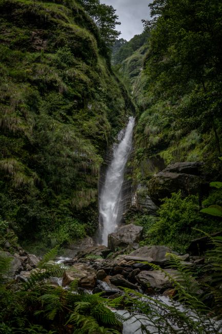 A stunning long exposure shot of a waterfall amidst a rich green jungle, perfect for nature photography.