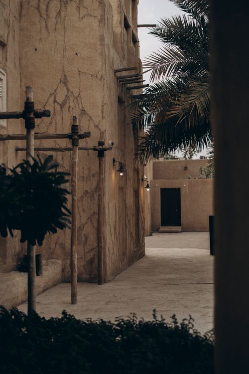Free Explore the rustic charm of Old Dubai's architectural style in warm lighting. Perfect for travel and cultural heritage enthusiasts. Stock Photo
