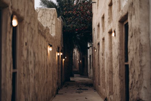 A dimly lit historic alleyway in Dubai showcasing traditional architecture and a serene atmosphere.