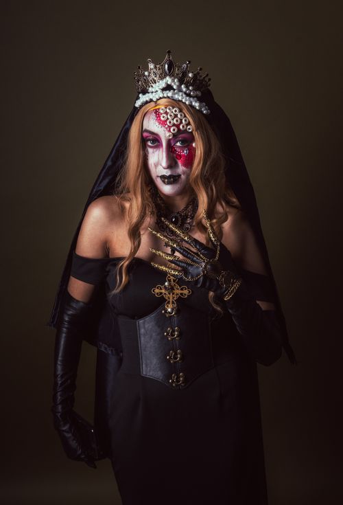 Free Artistic portrait featuring Dia de los Muertos inspired makeup and attire in Mexico City. Stock Photo