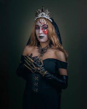 Stunning gothic portrait of a woman with intricate dark makeup, wearing an elegant crown and gloves.