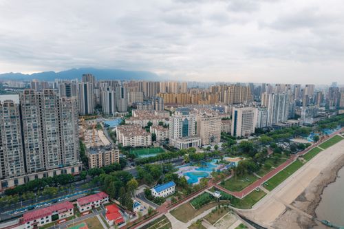 Free Aerial view of a bustling city with skyscrapers and parks, showcasing modern urban life in China. Stock Photo