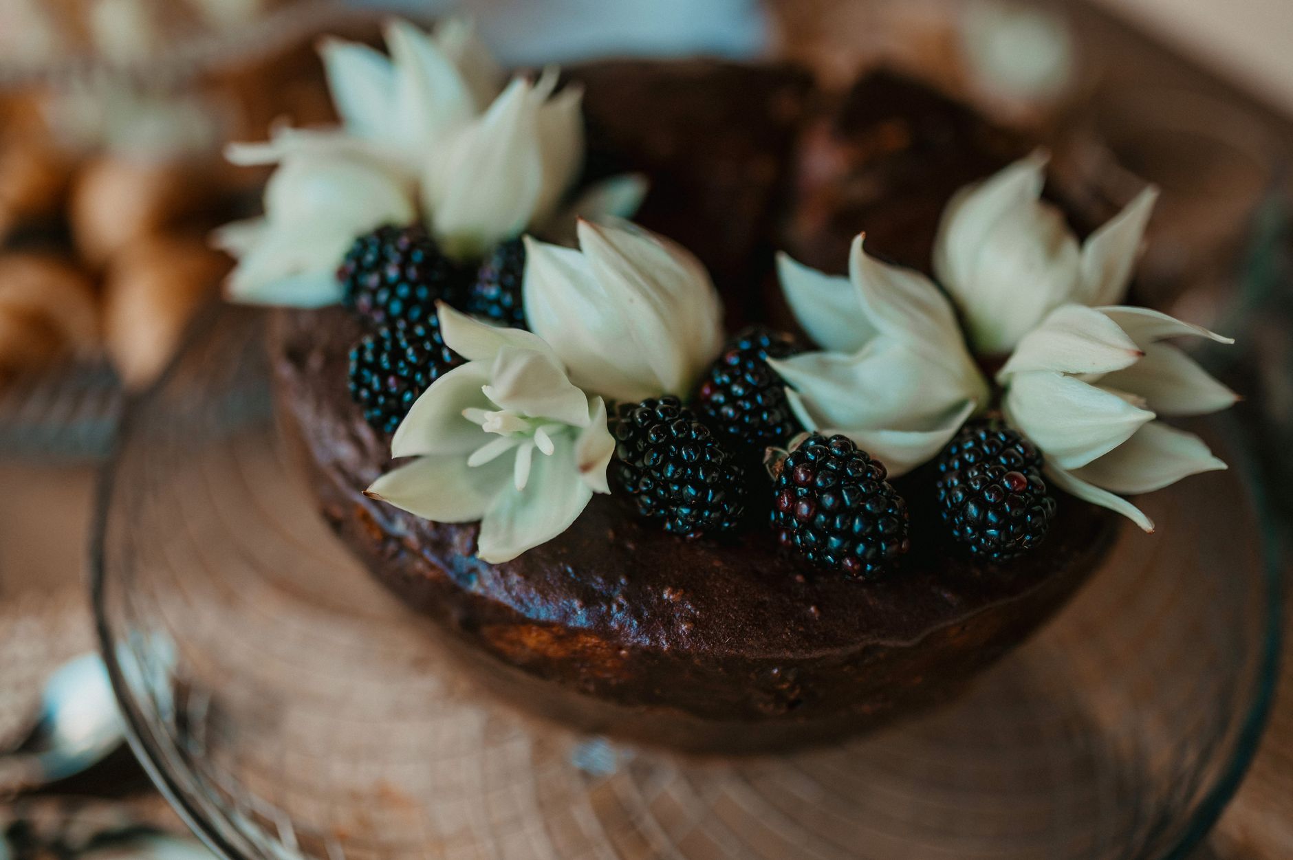 Delicious Chocolate Easter Egg Nests: A Fun Dessert Recipe Rustic chocolate cake garnished with fresh blackberries and flowers, perfect for elegant dining.