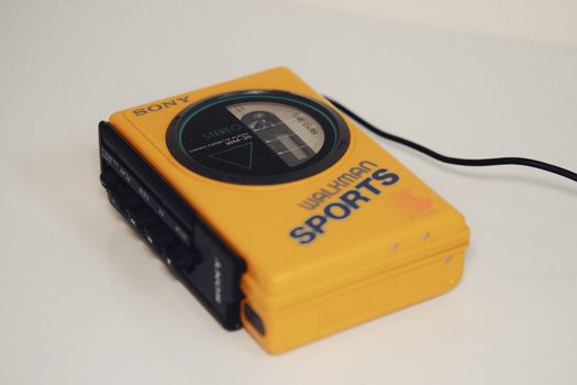 Retro yellow Sony Walkman sports cassette player with stereo feature.