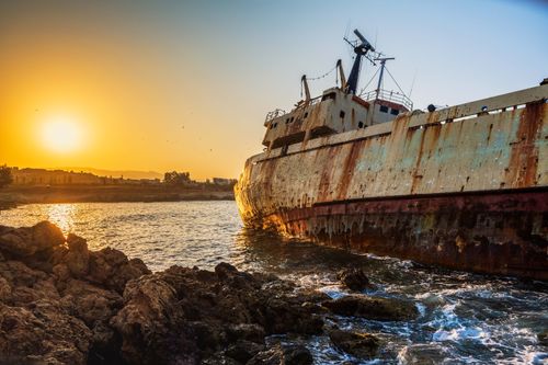 Free Rusty cargo shipwreck on Paphos coast, Cyprus, captured at sunrise with dramatic lighting. Stock Photo