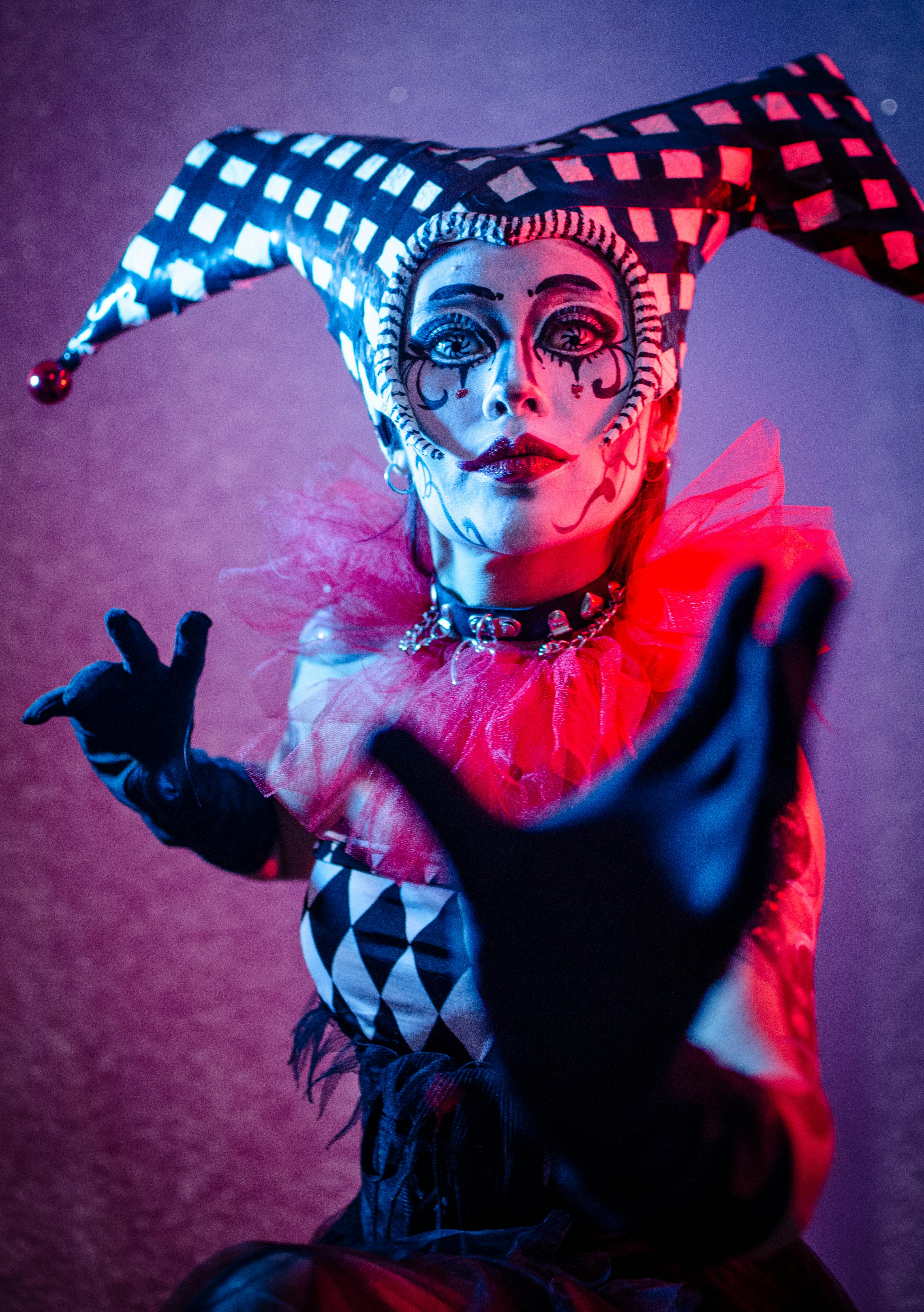 Gratis Spooky Harlekin Kostyme I Dramatisk Lyssetting Arkivbilde