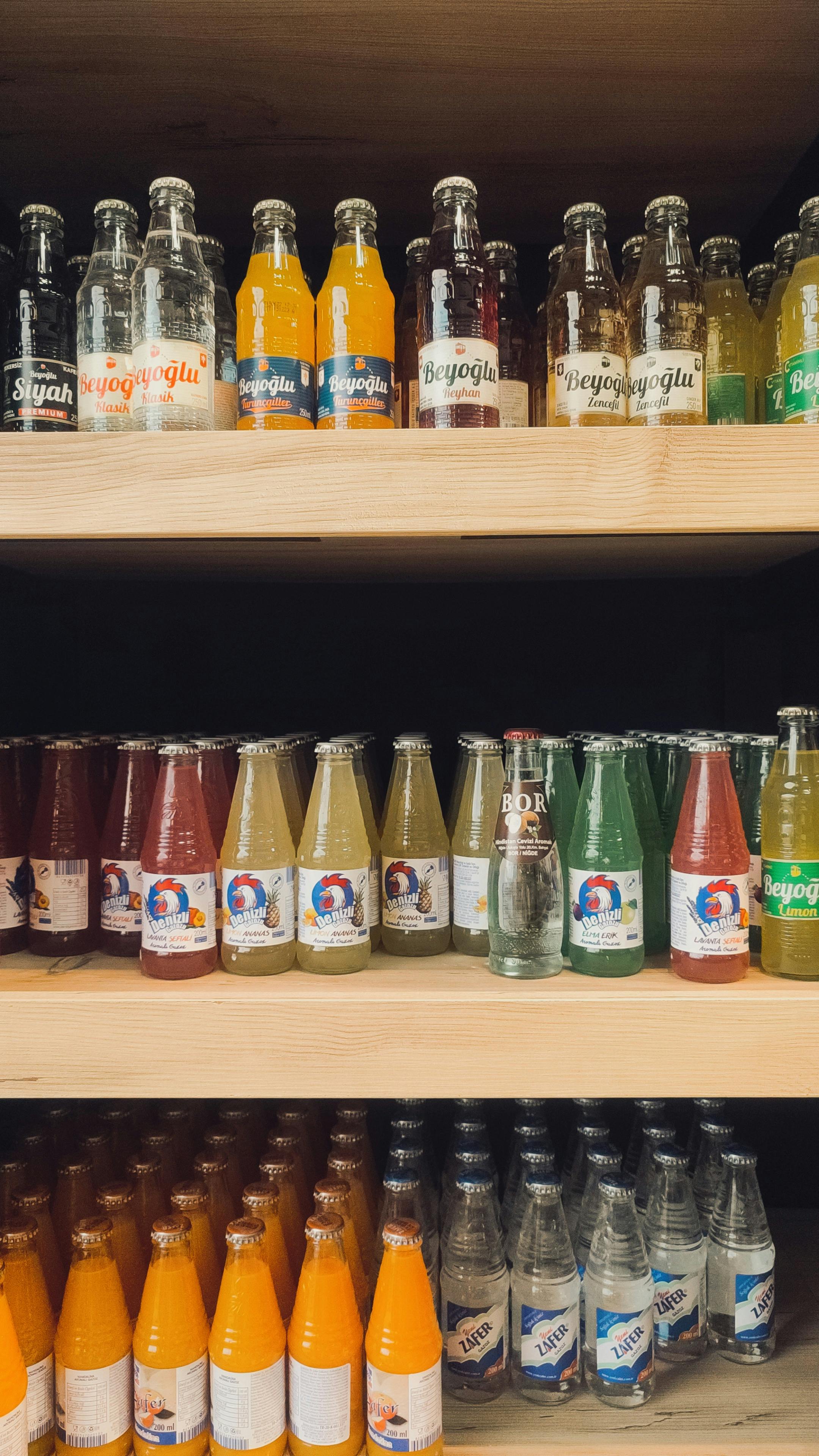Vibrant soda bottles arranged neatly on market shelves showcasing various flavors.