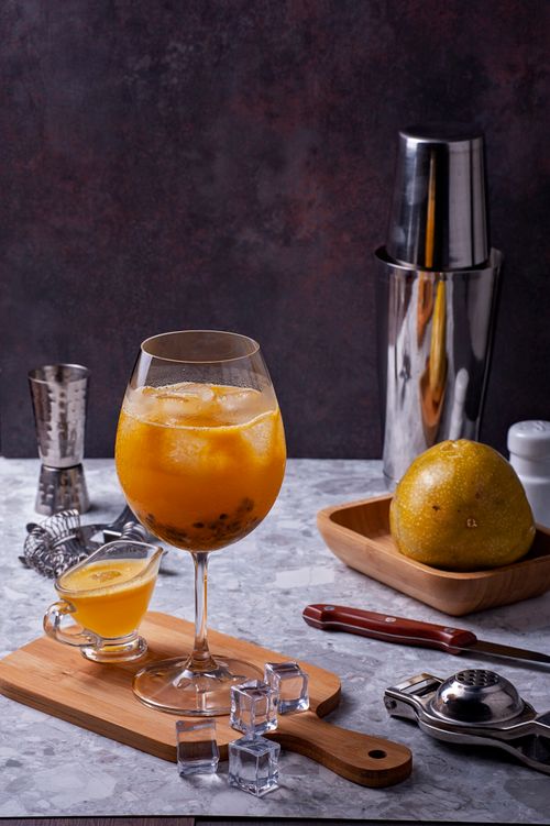 Free Elegant cocktail with fresh orange and lemon on a stylish bar countertop. Stock Photo