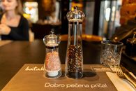 Close-up of salt and pepper shakers on a table in a Zagreb restaurant.