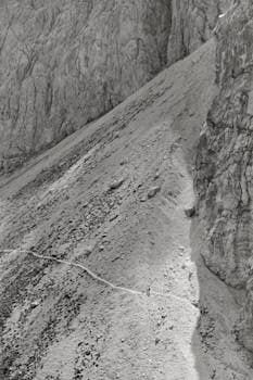 Explore the rugged trail on a steep mountain slope in Soca Valley, Slovenia. A striking adventure scene.