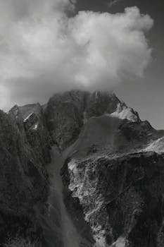Majestic mountain peaks shrouded in clouds in the Soča Valley, Slovenia.