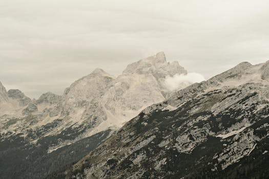 Captivating mountain landscape of the Soča Valley, Slovenia with rugged peaks and moody skies.