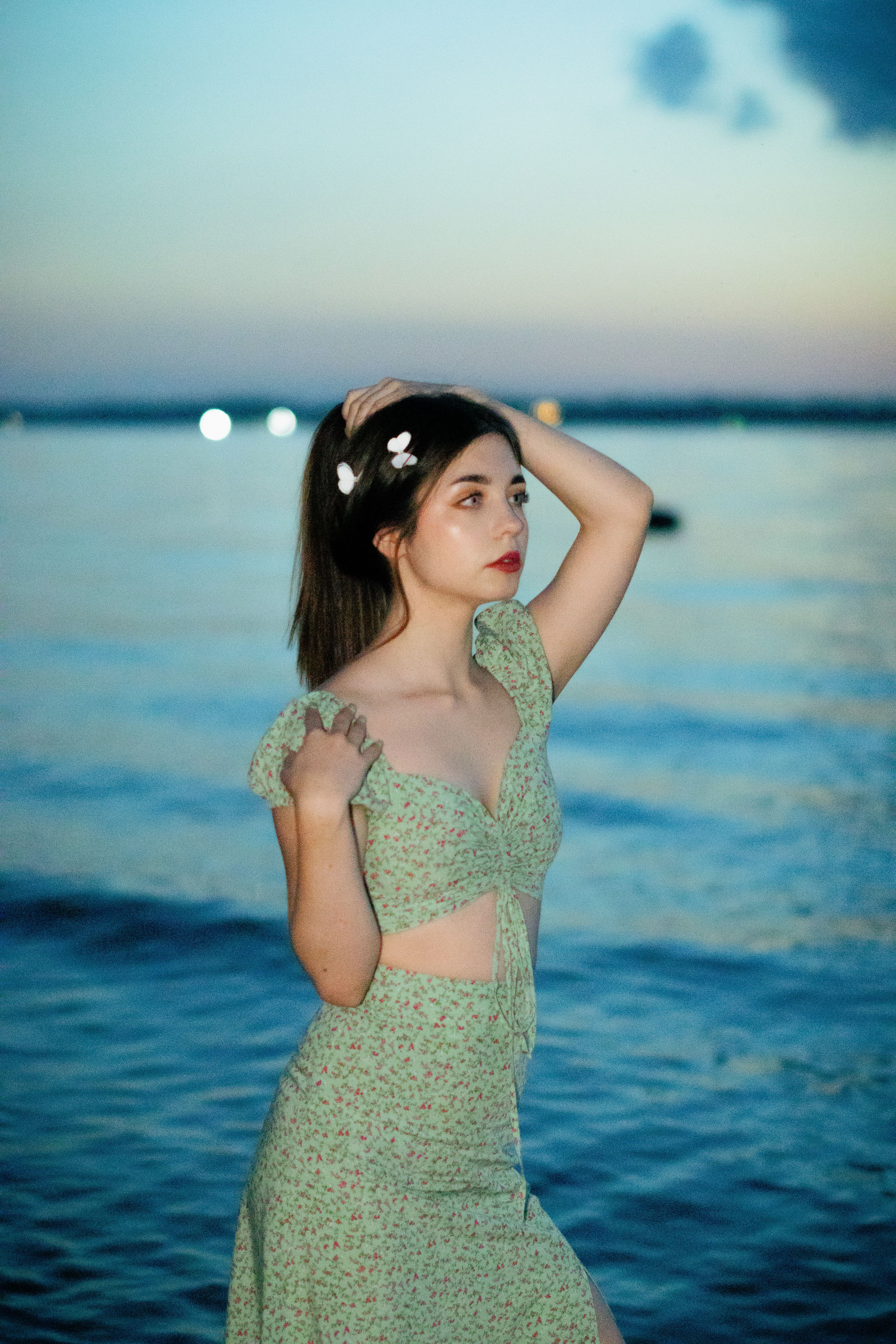 Elegant Woman Posing by the Sea at Sunset · Free Stock Photo