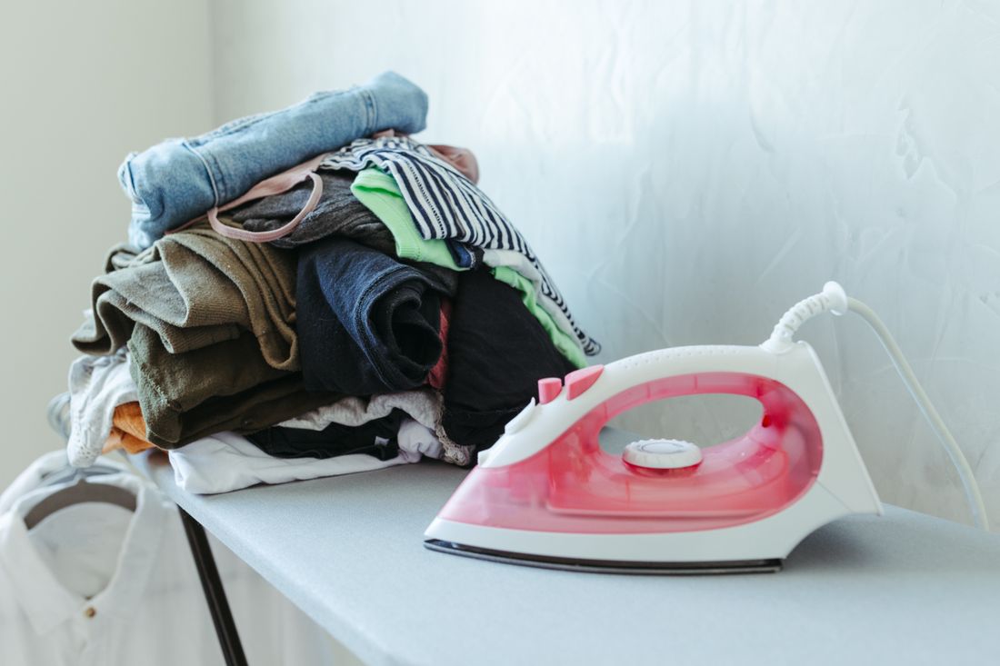 Care for different fabrics – stack of clothes ready to be ironed at the right temperature