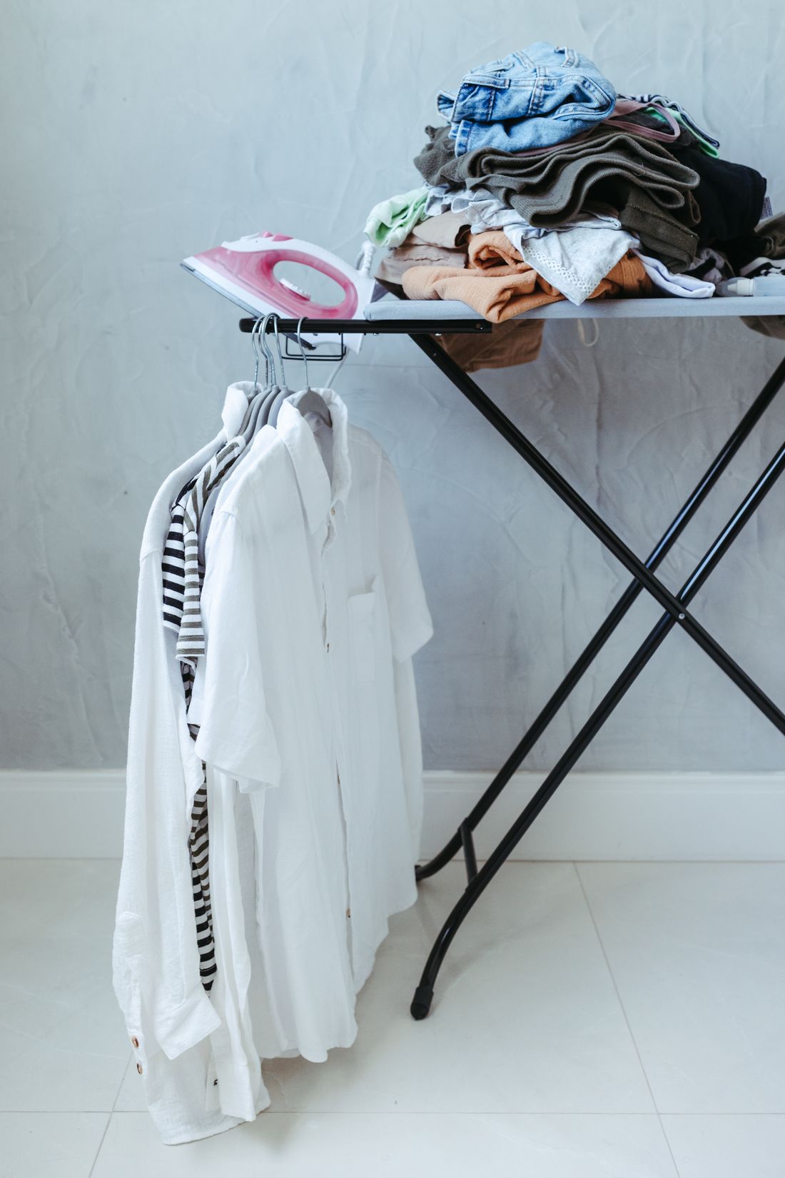 Ironing Pickup and Delivery Al Qirawan – ironing board with clothes ready for pressing