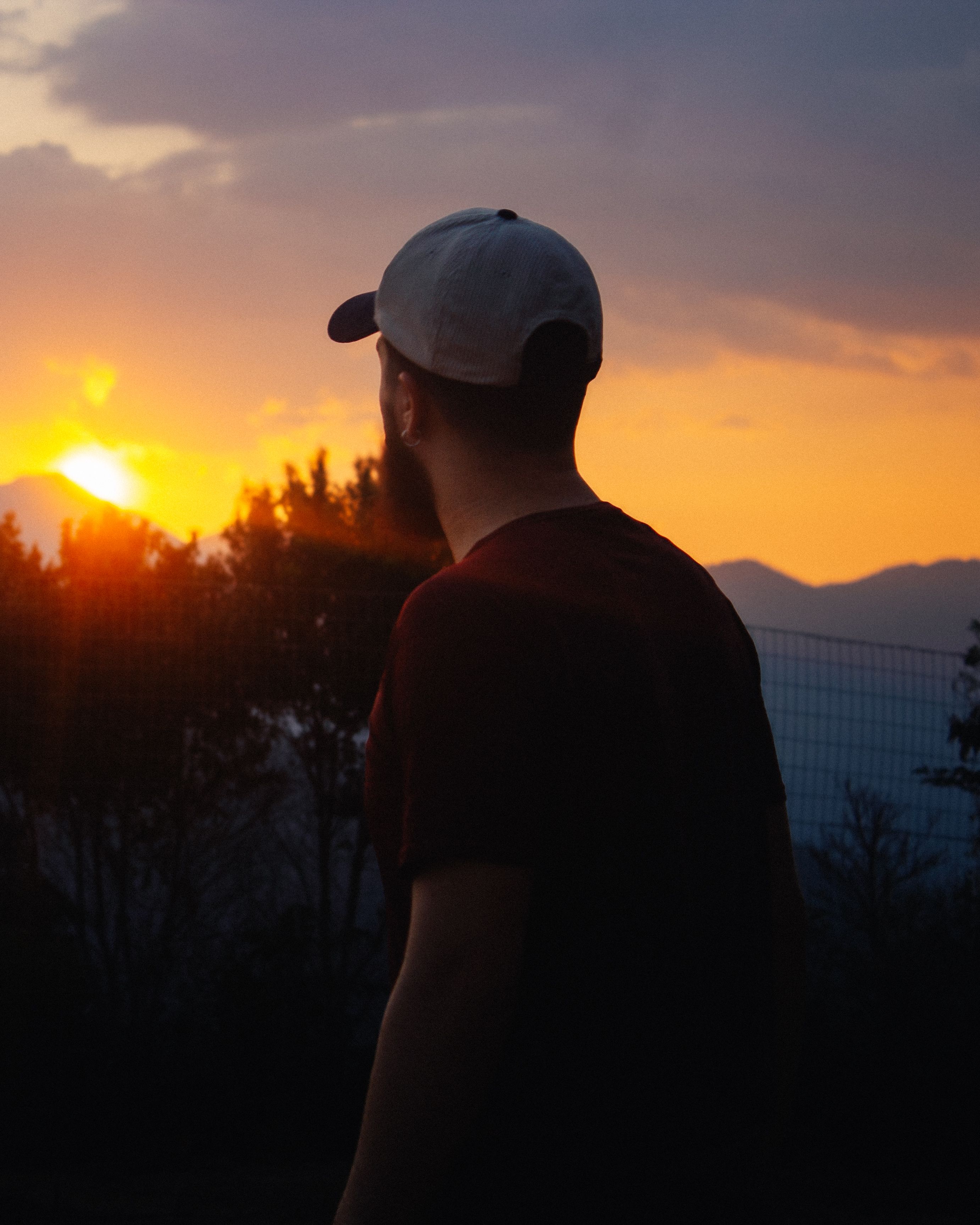 Man Witnessing Breathtaking Sunset Outdoors · Free Stock Photo