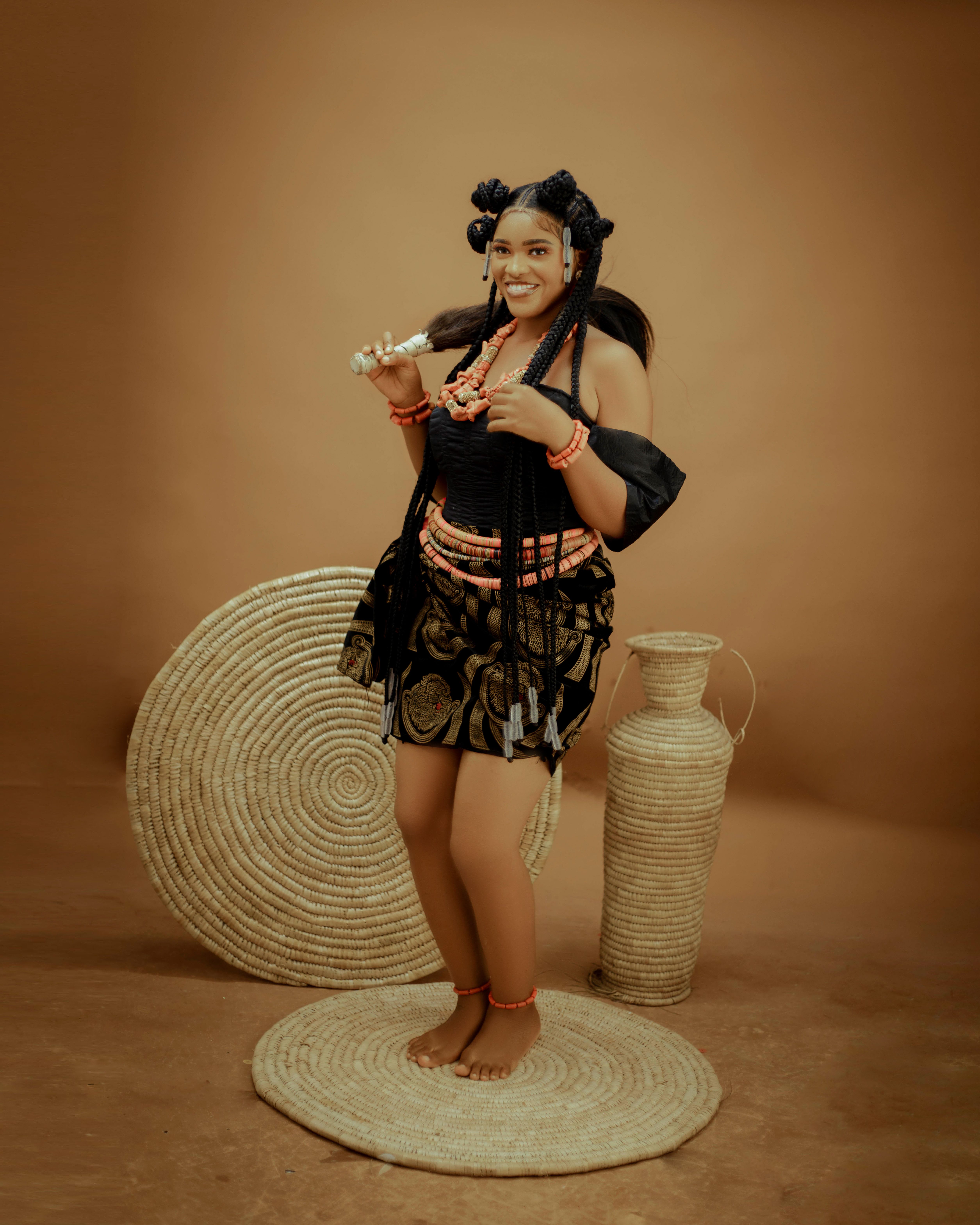Portrait of a woman in vibrant traditional African dress, expressing joy and heritage.