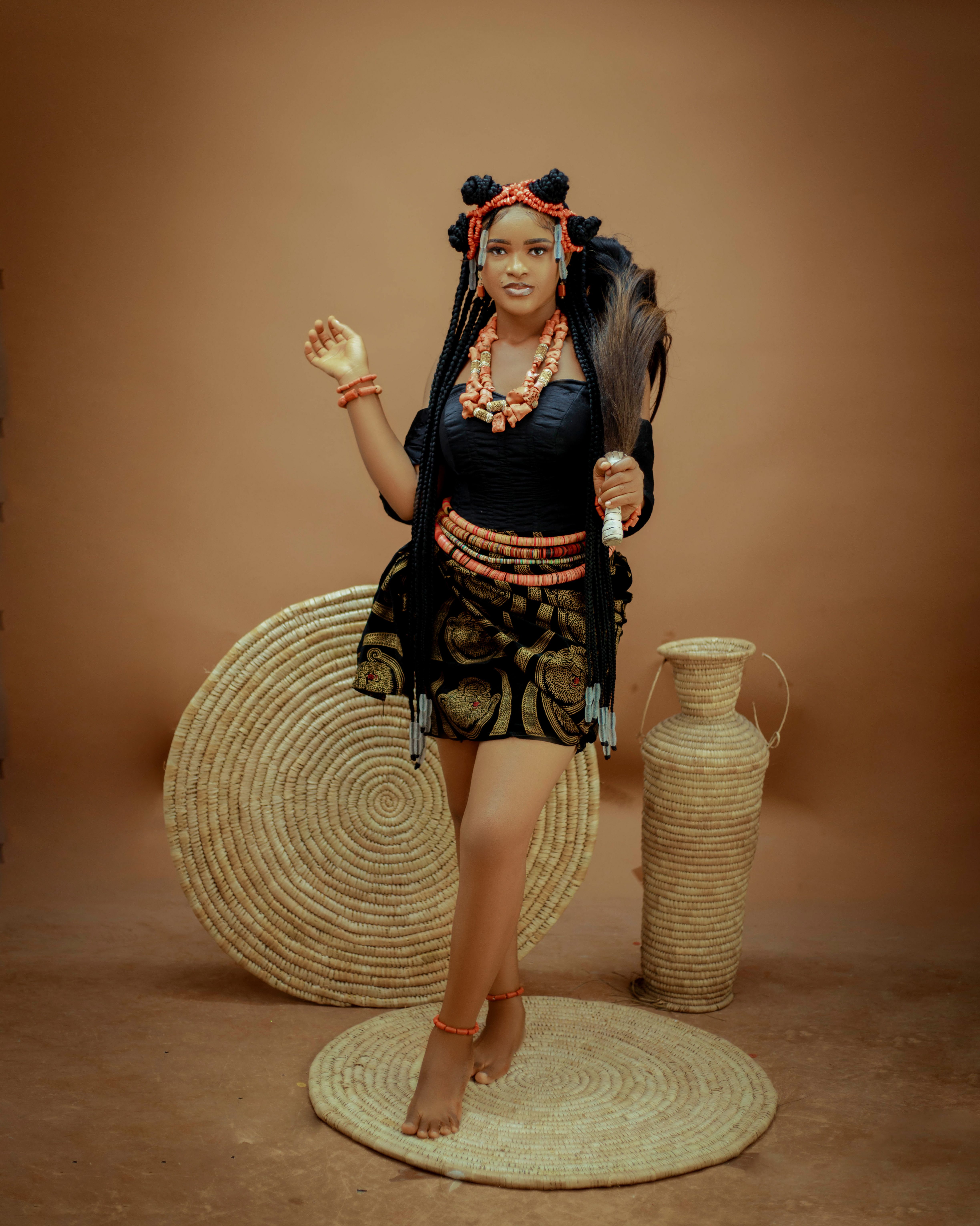 Woman in traditional African clothing with cultural décor and accessories.