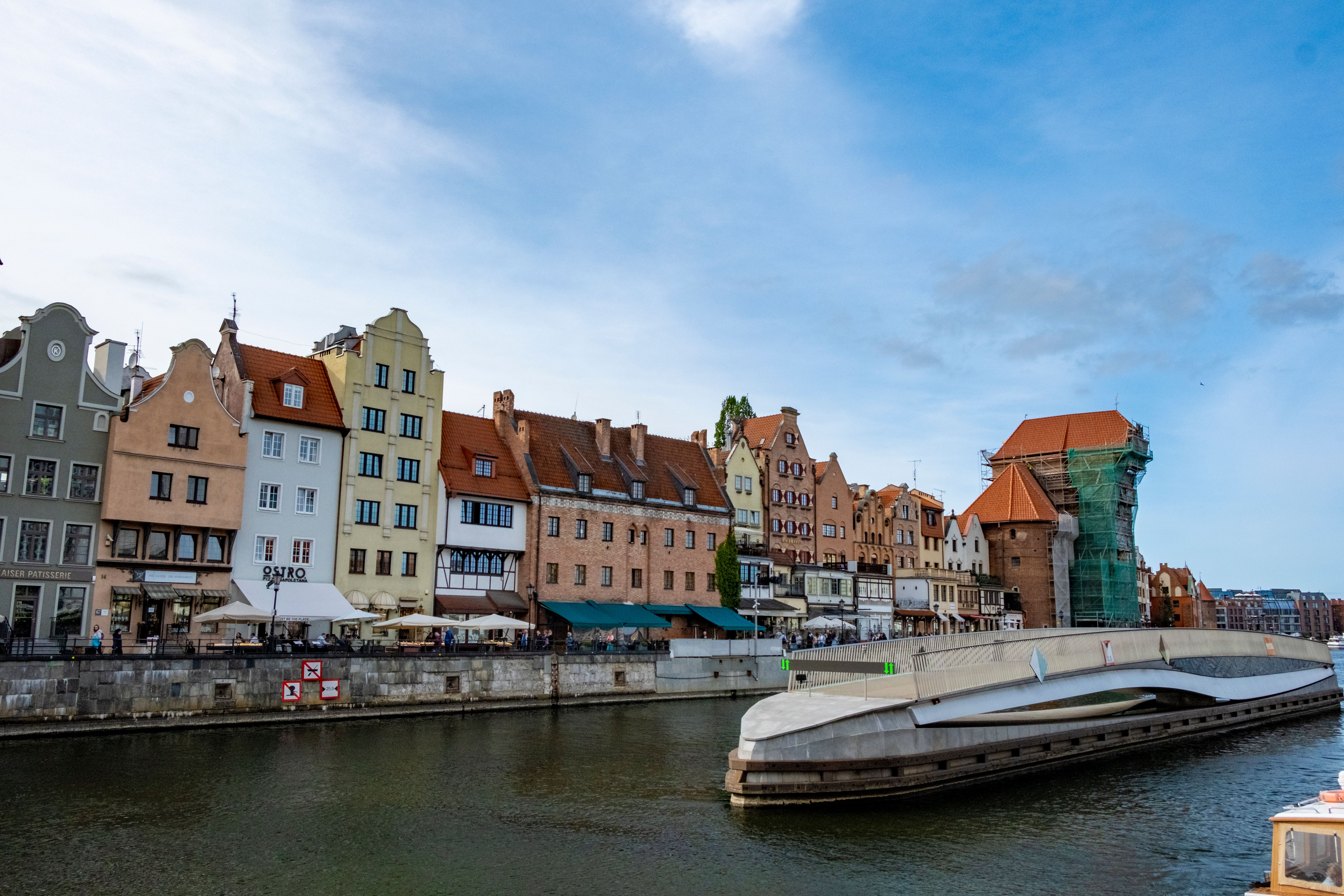 Gdańsk Old Town at golden hour with colorful Hanseatic buildings, Long Market square, and St. Mary's Basilica glowing in warm morning light