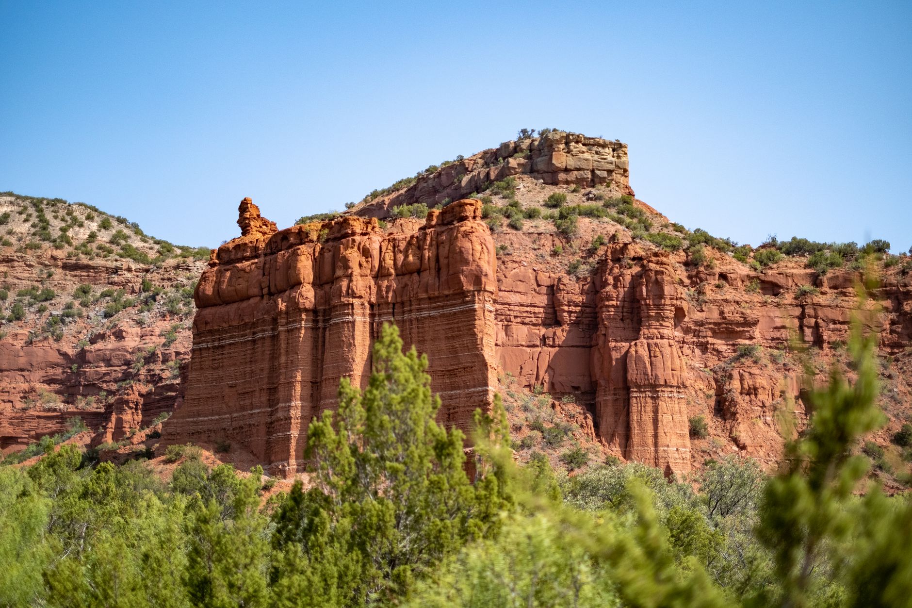 15 Texas State Parks That Feel Like Big Bend Without the 6-Hour Drive 7 Beautiful red rock formations under a clear blue sky in Quitaque, Texas.