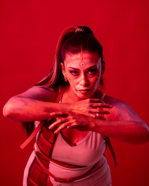 Free Creative portrait of a woman with bold makeup and red lighting, evoking intense emotions. Stock Photo