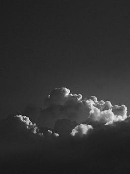Dark and dramatic black and white photo of clouds at twilight.