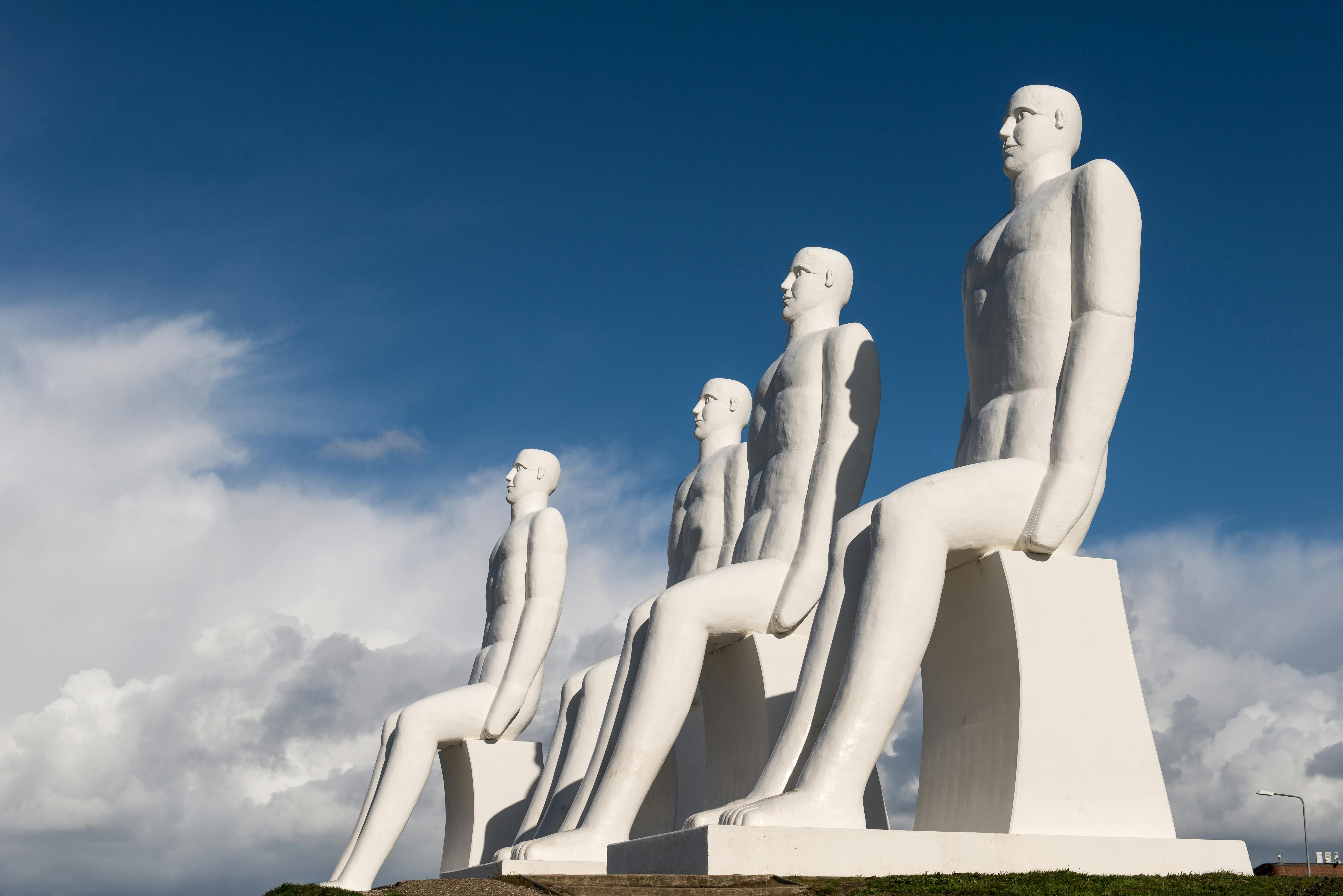 Monumental sculptures overlooking the North Sea in Esbjerg, Denmark, under a clear sky.