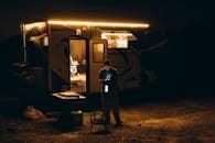 Night Camping Scene with Illuminated Caravan