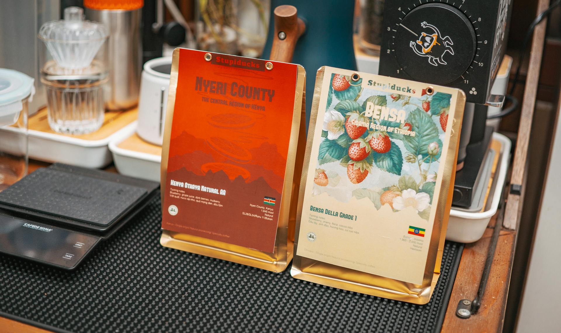 Coffee bags from Kenya and Ethiopia displayed on a wooden counter.