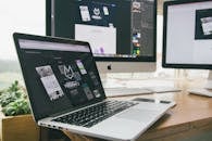 Macbook Pro Displaying Website Version 2 on Table