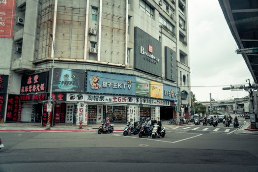 Vibrant urban street view in Taipei, Taiwan with busy traffic and city life.