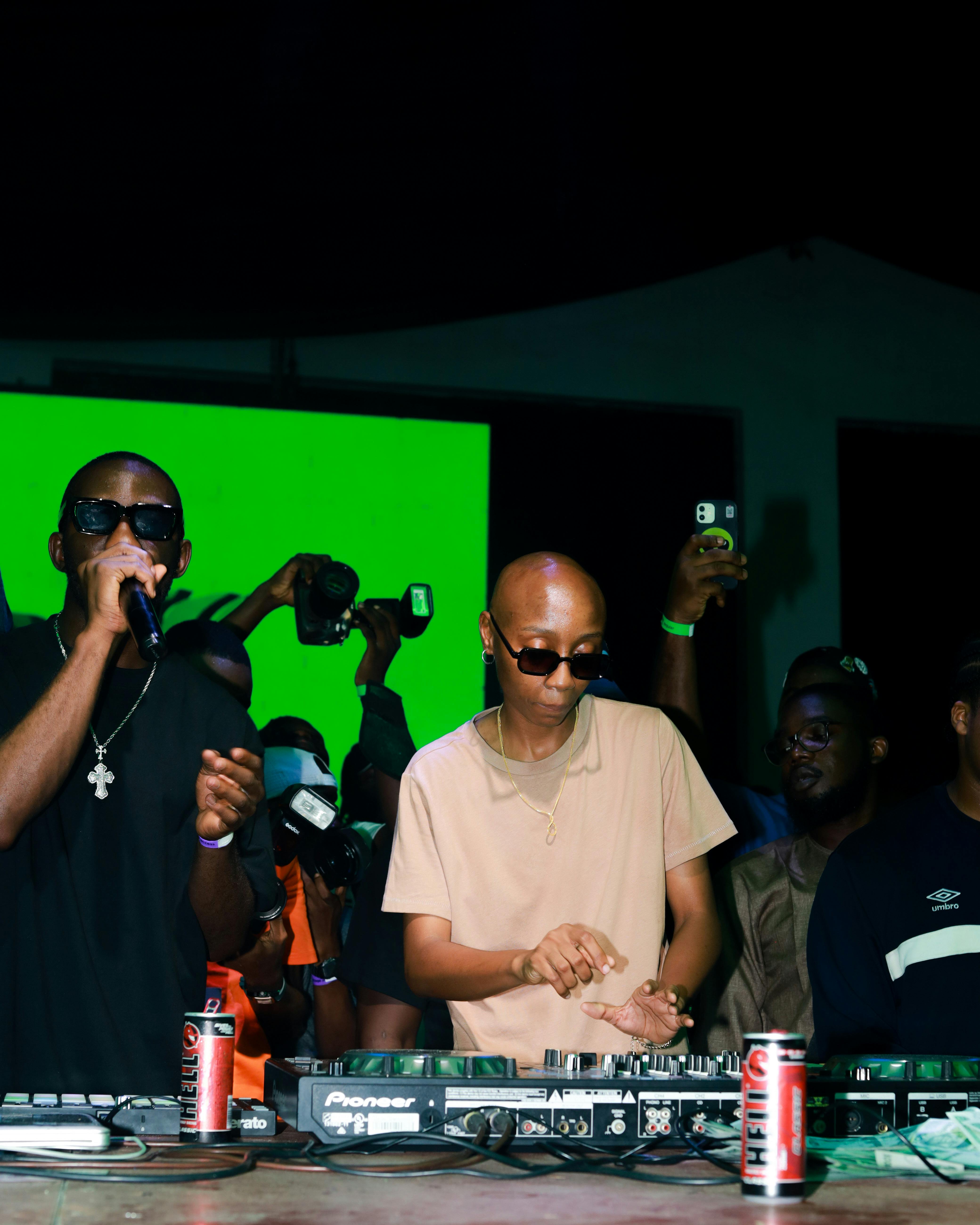 DJ and performer energizing the crowd at a vibrant nightclub event.