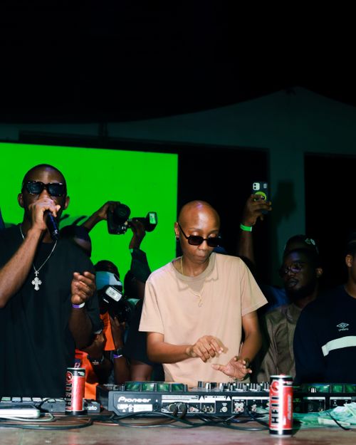 Free DJ and performer energizing the crowd at a vibrant nightclub event. Stock Photo