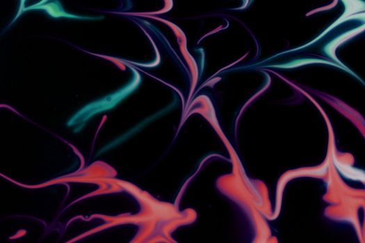 Colorful swirls of abstract fluid art create a vibrant contrast on a dark background.