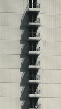 Minimalist high-rise building facade with vertical balconies.