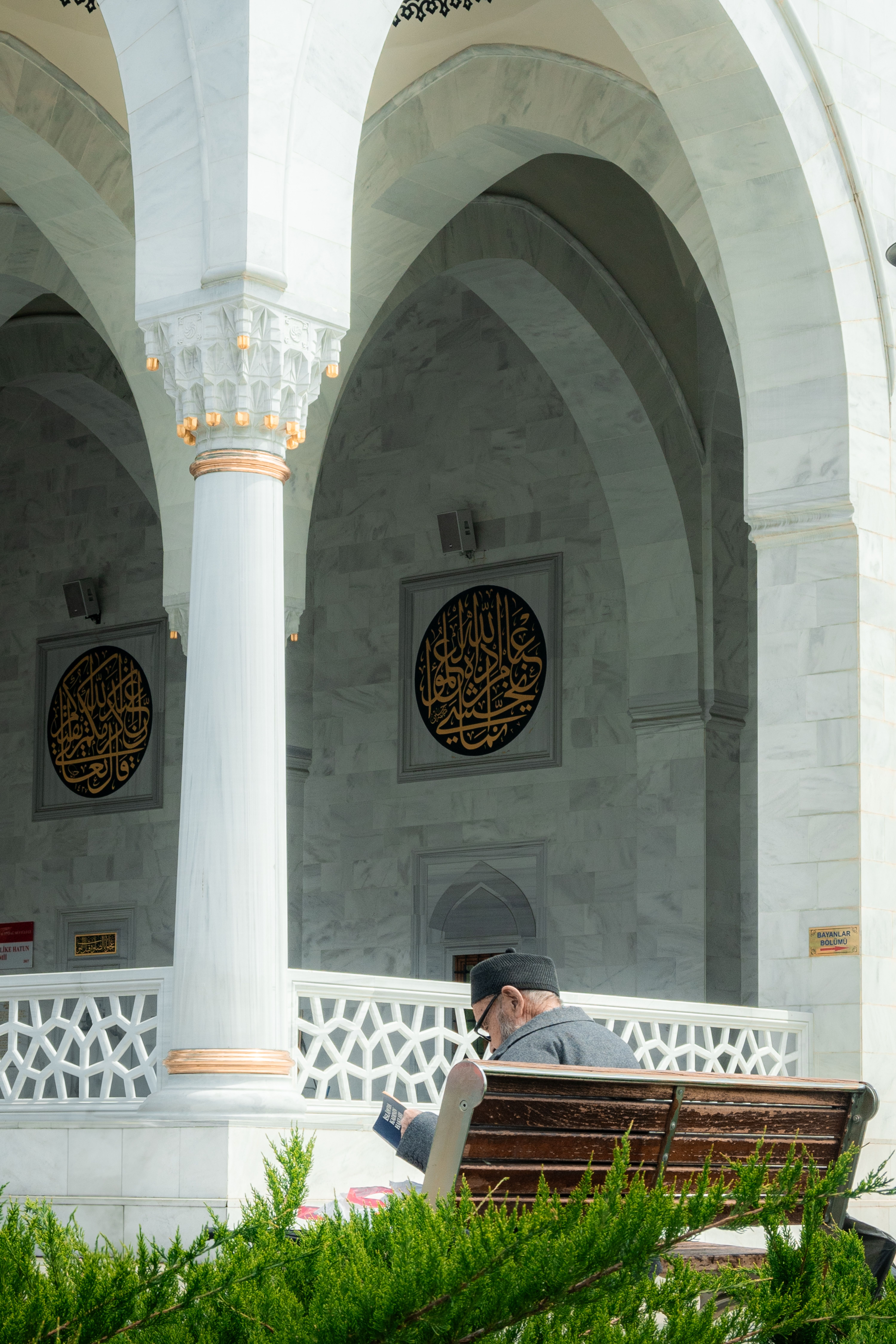 Man Reading Outside a Marble Mosque in Daylight · Free Stock Photo