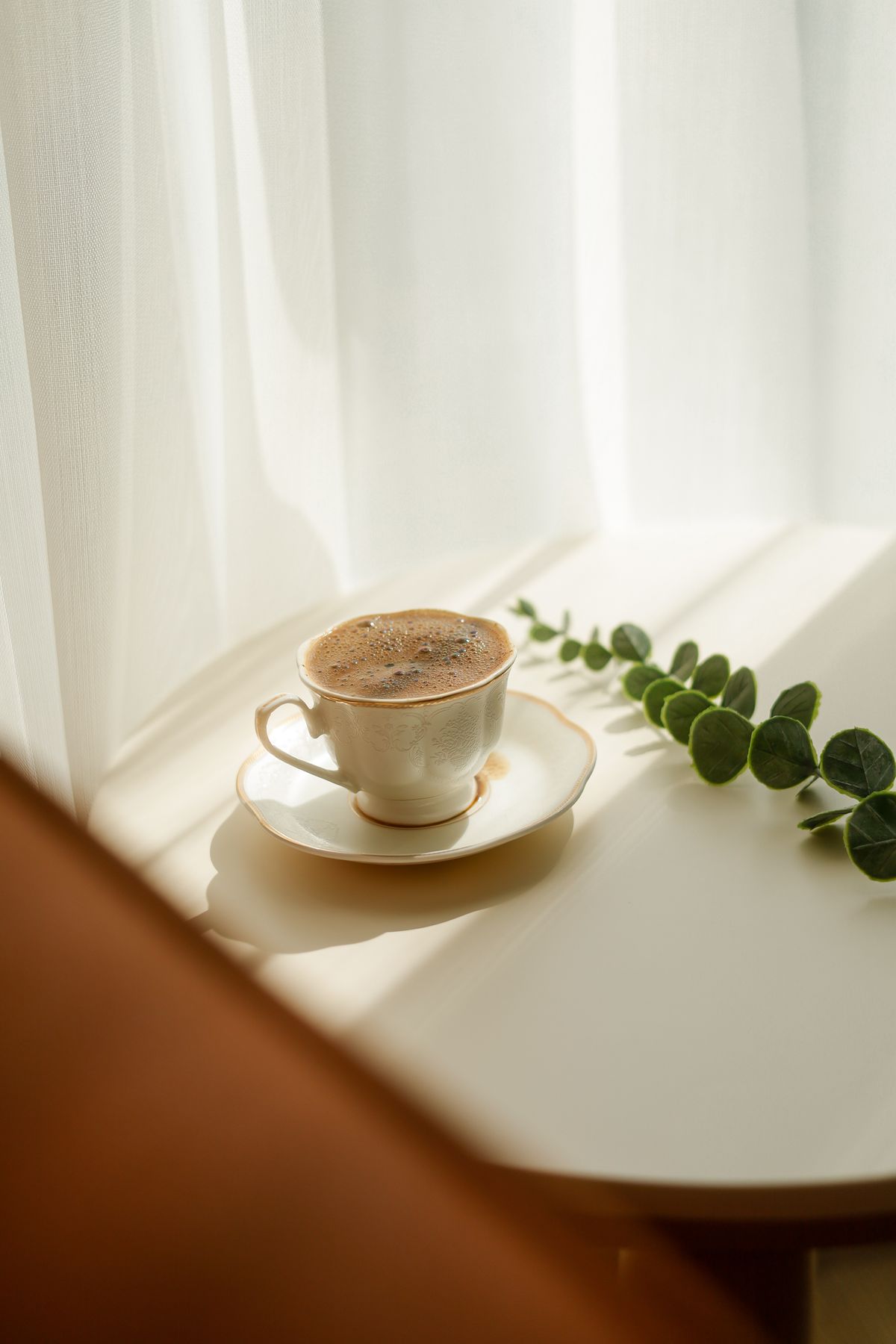 Cozy morning coffee by the window in warm sunlight