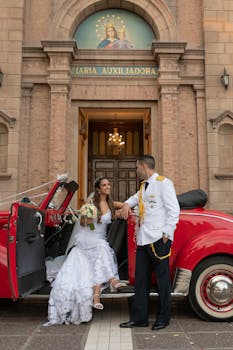 Elegant wedding scene with bride and groom outside Mendoza church, Argentina.