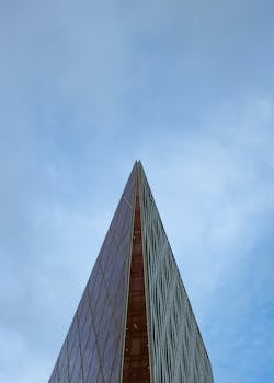 Minimalist architectural shot of a London skyscraper reaching into the blue sky.